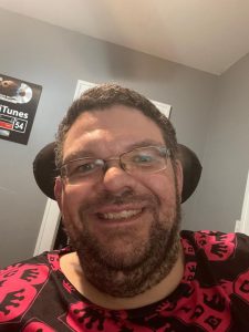 Author B-Cide wearing signature B-Cide logo T-shirt – rapper, producer, and memoir author
